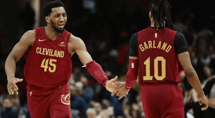 Cleveland-cavaliers vs Dallas Mavericks Picks and Predictions February 2nd 2025 2 Cleveland Cavaliers players Donovan Mitchell (#45) and Darius Garland (#10) share a high five during a game