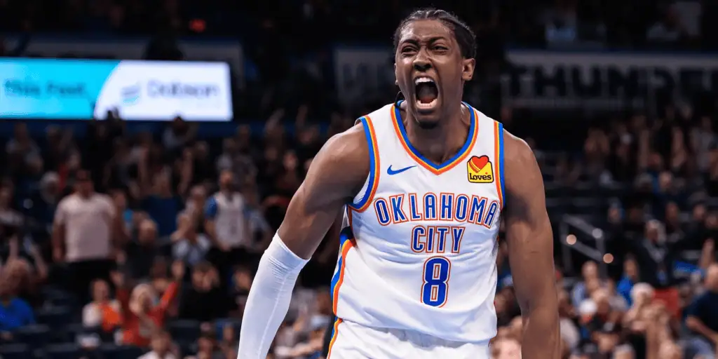 Utah Jazz vs Oklahoma City Thunder Picks and Predictions February 21st 2025 2 A basketball player in an Oklahoma City Thunder jersey celebrates energetically on the court, surrounded by cheering fans.