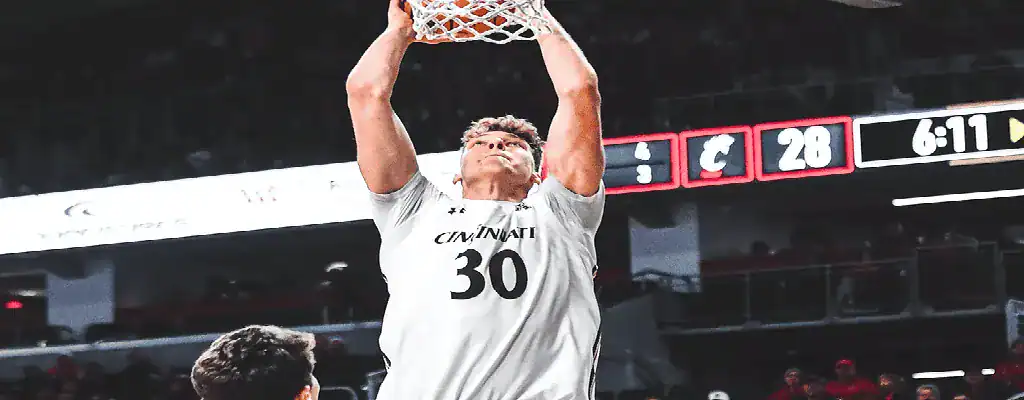 Clemson Tigers vs North Carolina Tar Heels Picks and Predictions February 10th 2025 2 Cincinnati Bearcats player dunks the ball during NCAA basketball game