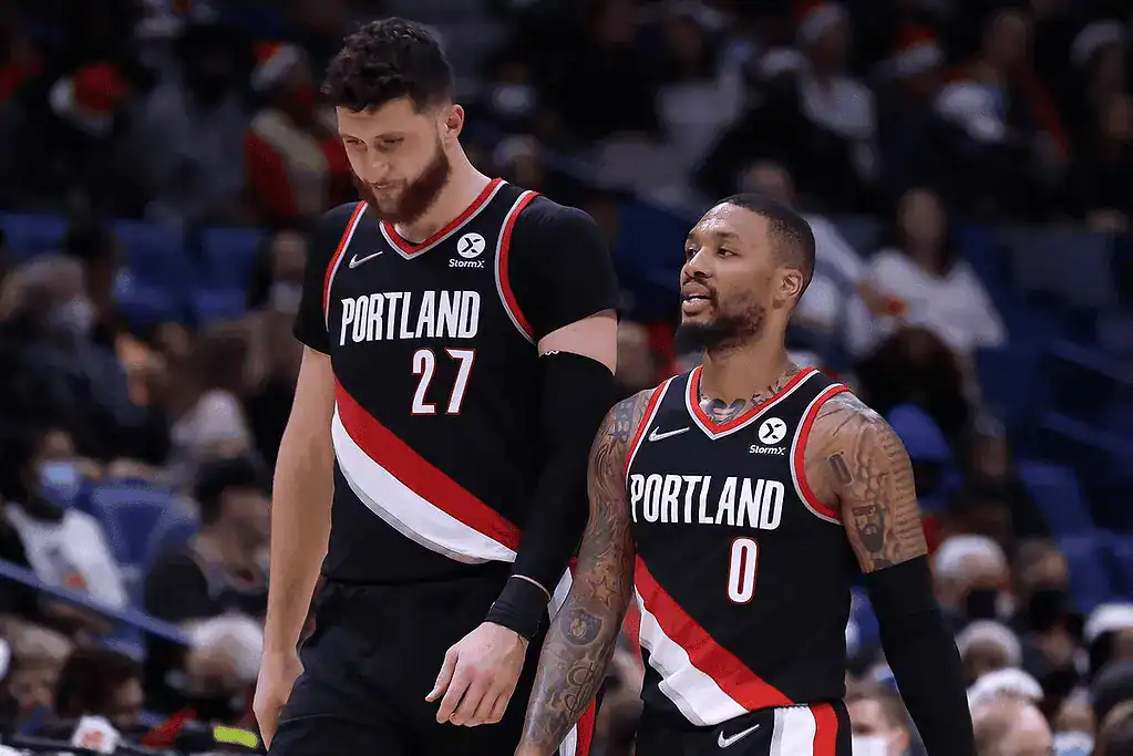Philadelphia-76ers vs Portland Trail Blazers Picks and Predictions March 3rd 2025 4 Two Portland Trail Blazers players, one tall with jersey number 27 and the other with jersey number 0, walk together on the court.