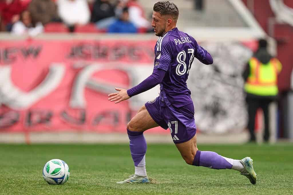 Orlando city Player dribbling past a player