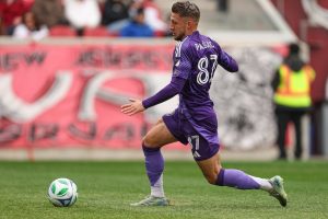Orlando city Player dribbling past a player