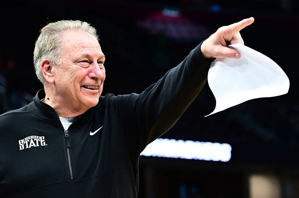 NCAAB Coach celebrating with his team