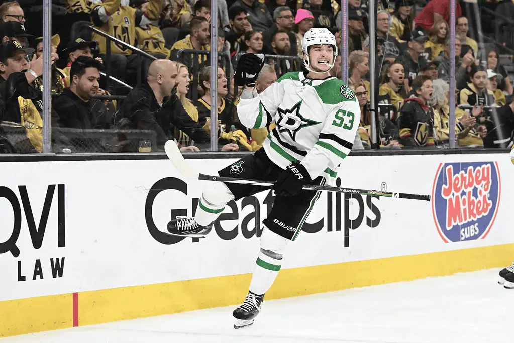 Dallas Stars vs New Jersey Devils Picks and Predictions March 4th 2025 2 A hockey player in a green and black uniform celebrates a goal in front of an energetic crowd wearing gold jerseys.