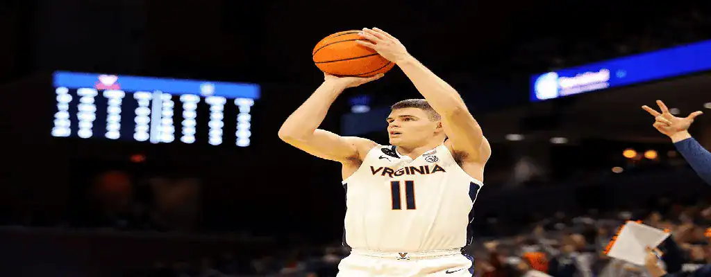 Virginia Cavaliers basketball player takes a jump shot during NCAA game