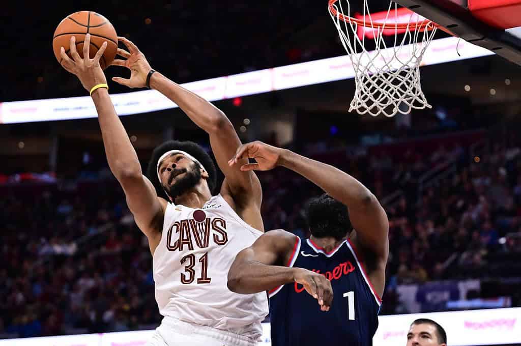 Cavs player dunking on another player