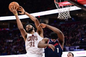 Cavs player dunking on another player