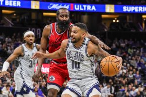 Magic Player Dribbling past James Harden