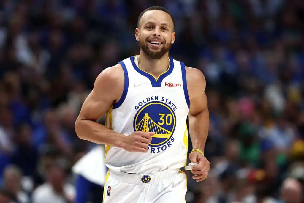 Golden State Warriors vs Houston Rockets Picks and Predictions April 26th 2025 2 A muscular basketball player in a Golden State Warriors jersey runs on the court