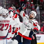 washington capitals player high fiving his teammates