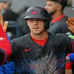Toronto Blue Jays player celebrates with teammates after scoring against Oakland Athletics on