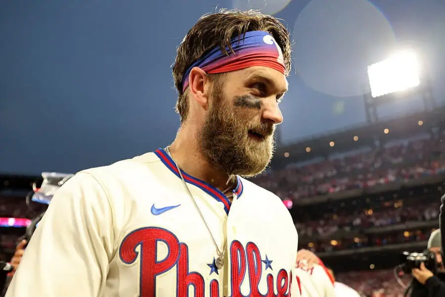 Cleveland Guardians vs Philadelphia Phillies Picks and Predictions May 11th 2025 2 A Philadelphia baseball player walks off the field, wearing a team jersey and a headband, amidst a bright stadium backdrop.