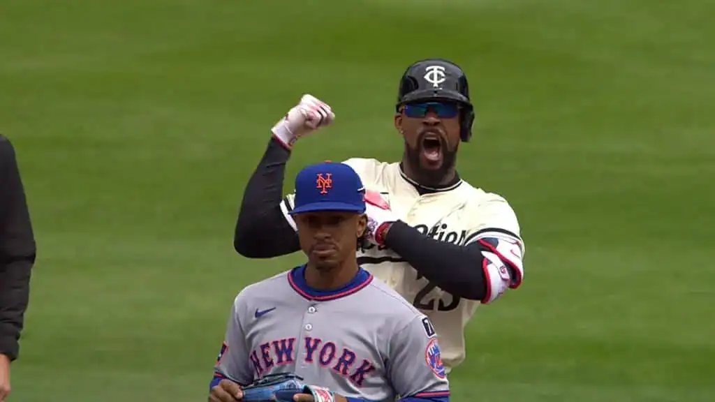 Seattle Mariners vs Minnesota Twins Picks and Predictions May 30th 2025 2 A baseball player in a white jersey celebrates, flexing his arm, while another player in a gray "New York" jersey looks on.