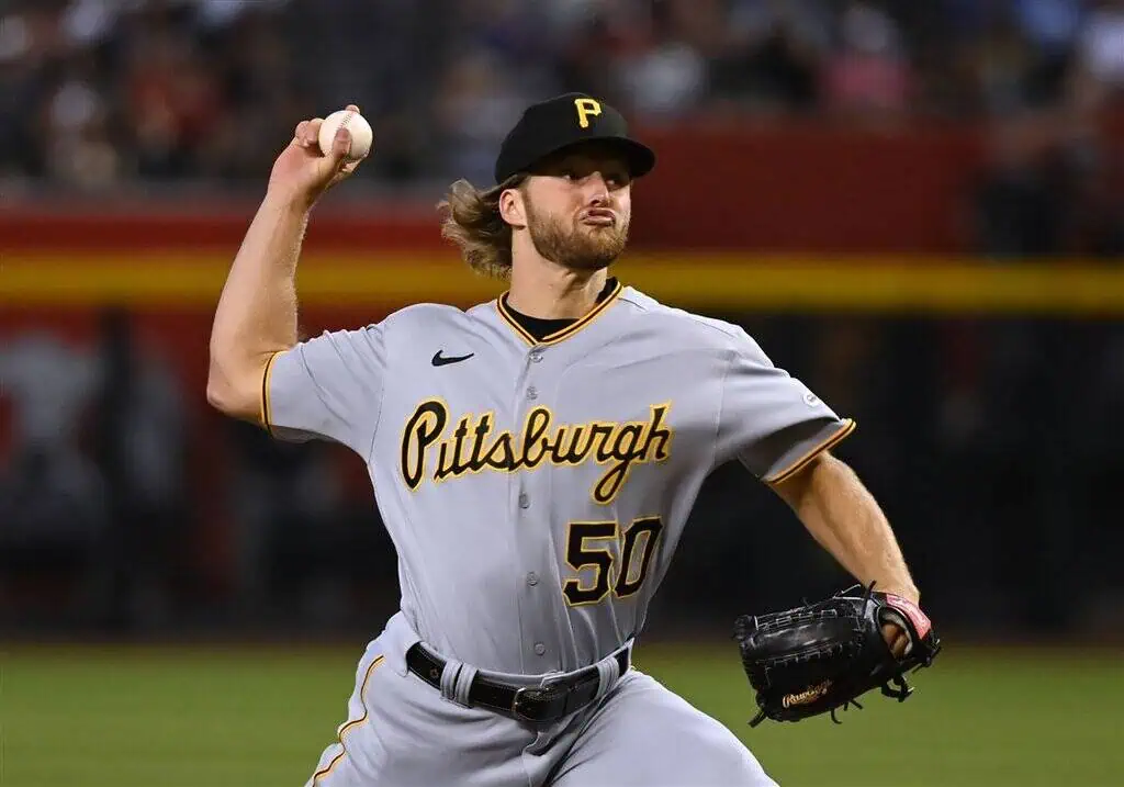 Pittsburgh Pirates vs Atlanta Braves Picks and Predictions May 11th 2025 2 A Pittsburgh Pirates pitcher in a gray uniform throws a baseball on the field during a night game, showcasing athletic focus and intensity.