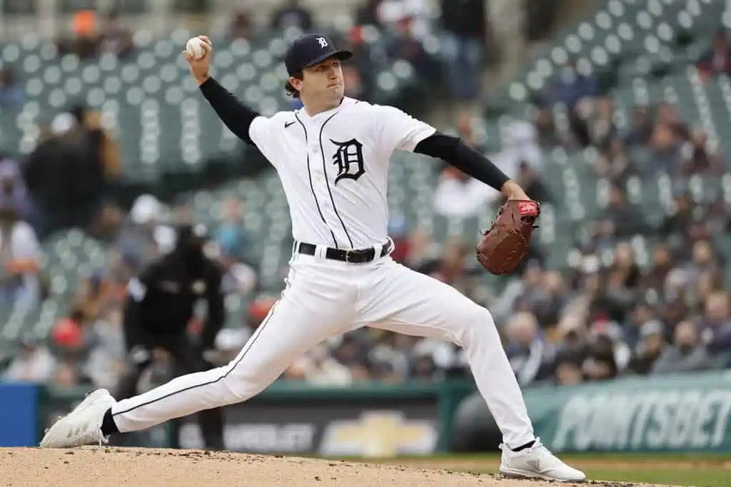 Detroit Tigers vs Boston Red Sox Picks and Predictions May 13th 2025 2 A pitcher in a white baseball uniform throws a ball on the mound during a game, with an empty stadium in the background.