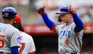 Chicago Cubs player celebrates after reaching base against Rockies
