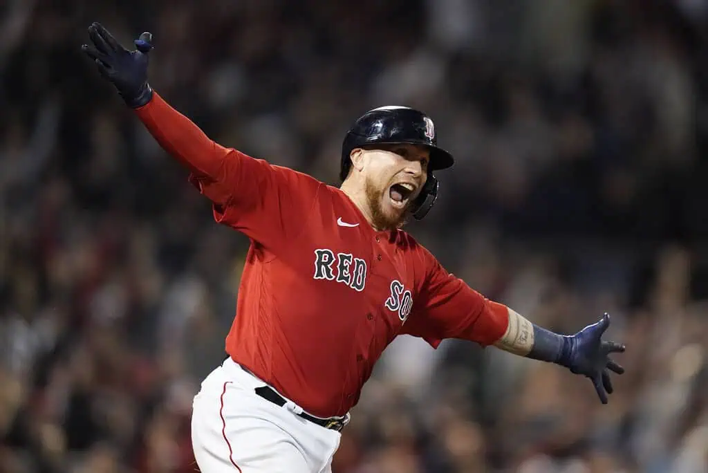 Cleveland Guardians vs Minnesota Twins Picks and Predictions May 1st 2025 2 A Boston Red Sox player celebrates enthusiastically on the field, wearing a bright red jersey, amidst a cheering crowd at a baseball game.