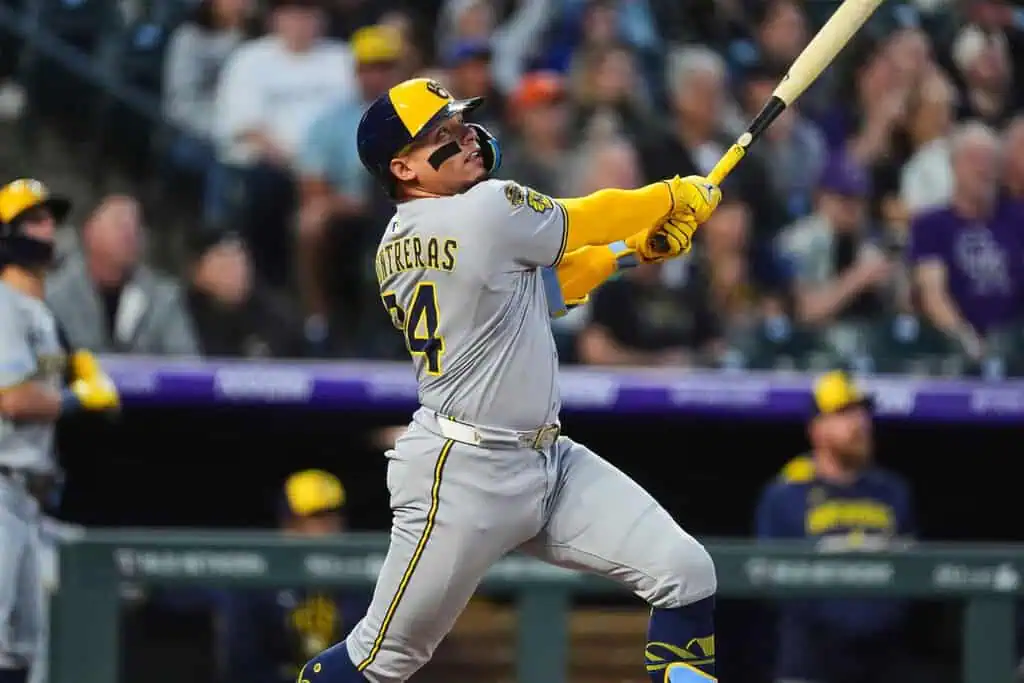 Chicago White Sox vs Milwaukee Brewers Picks and Predictions May 1st 2025 2 A baseball player in a gray uniform swings a bat during a game, facing an audience in a stadium filled with fans.