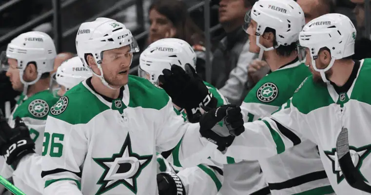 Dallas Stars vs Colorado Avalanche Picks and Predictions May 3rd 2025 3 Multiple Dallas Stars players in white and green jerseys celebrate with high-fives during an NHL game.