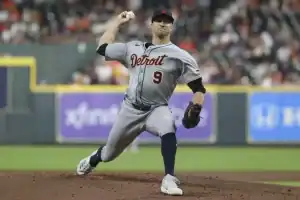 A Detroit Tigers pitcher in gray uniform throws a baseball on the mound during a game