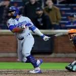 Los Angeles Dodgers batter follows through on swing as New York Mets catcher watches during May 24, 2025 game.