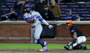 Los Angeles Dodgers batter follows through on swing as New York Mets catcher watches during May 24, 2025 game.