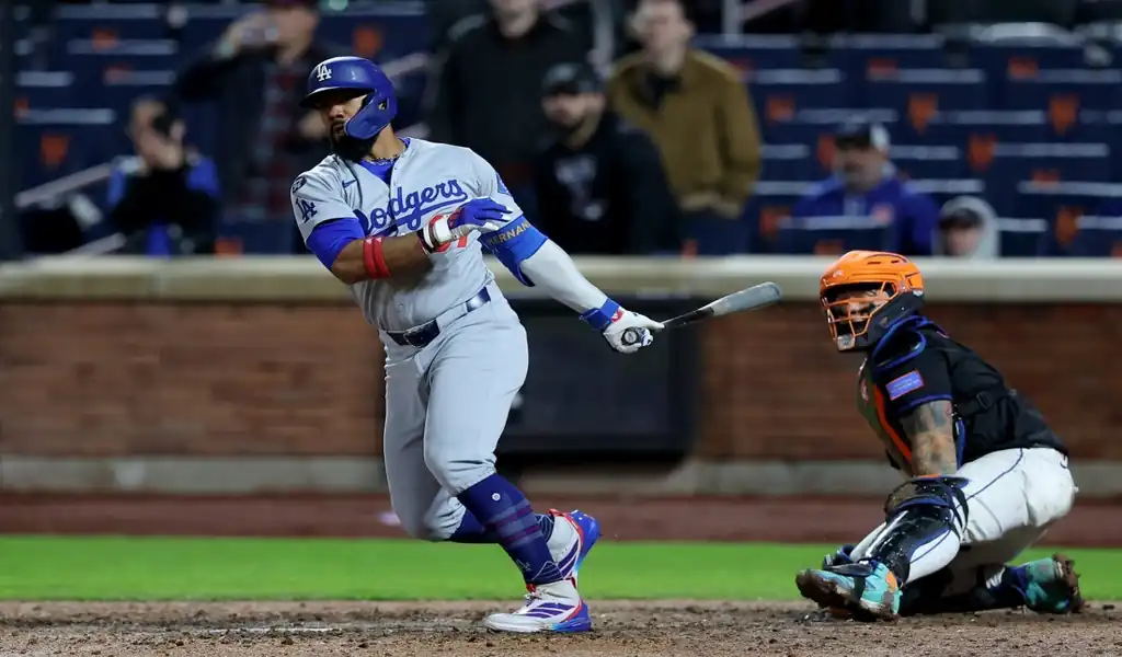 Los Angeles Dodgers batter follows through on swing as New York Mets catcher watches during May 24, 2025 game.
