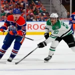 Edmonton Oilers and Dallas Stars players battle for puck in NHL playoff game