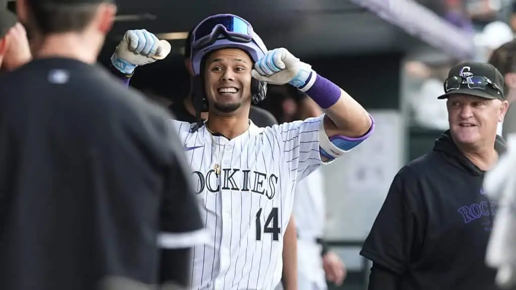 Colorado Rockies vs Detroit Tigers Picks and Predictions May 6th 2025 2 A baseball player in a Rockies jersey flexes his muscles in celebration while surrounded by teammates in the dugout.