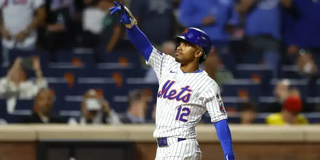 New York Mets vs Chicago White Sox Picks and Predictions May 27th 2025 2 A New York Mets player in a home jersey celebrates a play, pointing upward as fans cheer in the vibrant stadium background.