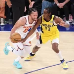 A New York Knicks player dribbles the ball