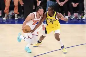 A New York Knicks player dribbles the ball