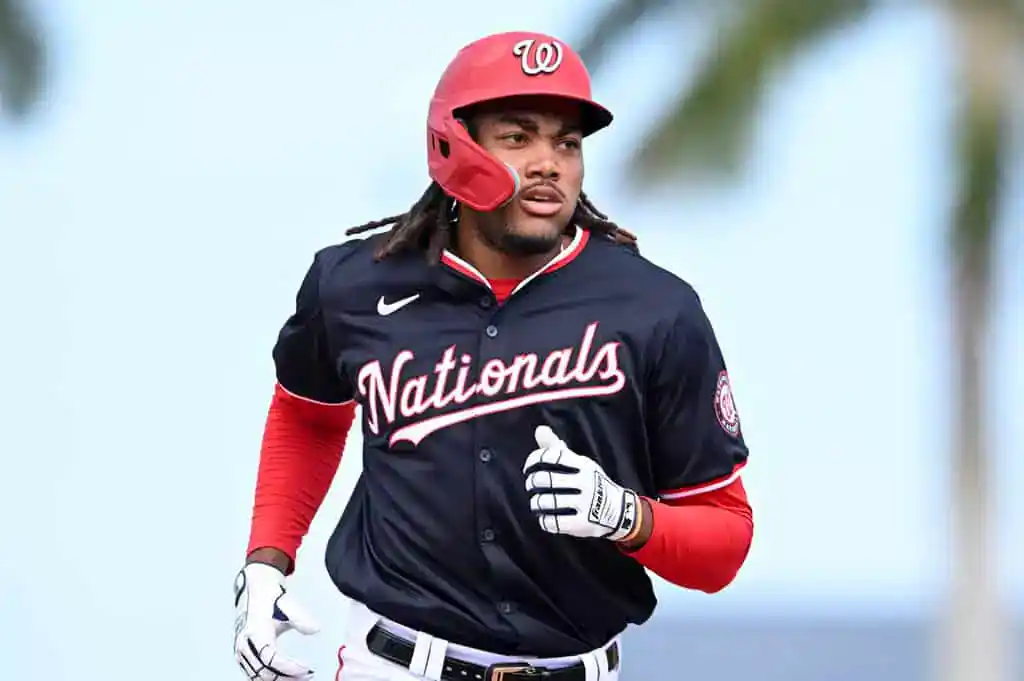 Seattle Mariners vs Washington Nationals Picks and Predictions May 29th 2025 2 A baseball player wearing a black Nationals jersey runs in a training session under palm trees, showcasing athleticism and focus.