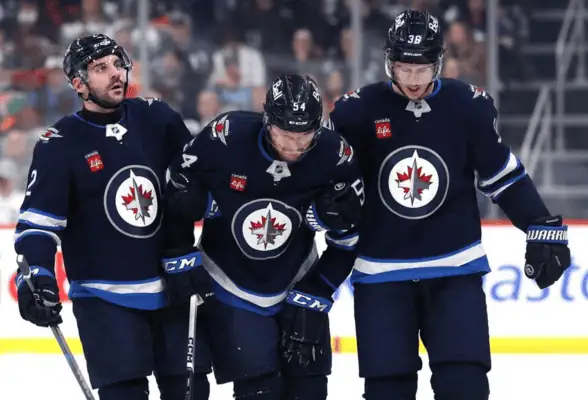 Winnipeg Jets vs Dallas Stars Picks and Predictions May 9th 2025 3 Winnipeg Jets players help teammate off the ice during NHL game