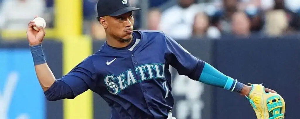 Oakland Athletics vs Seattle Mariners Picks and Predictions May 5th 2025 2 A Seattle Mariners player in a navy jersey throws a baseball while wearing a vibrant green glove on the field during a game.