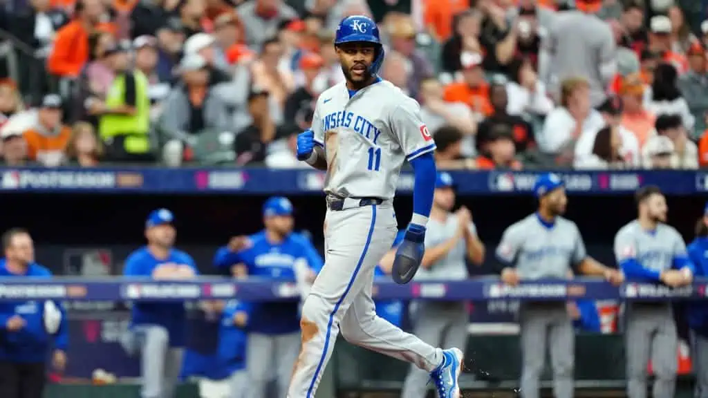 Kansas City Royals vs Chicago White Sox Picks and Predictions May 5th 2025 2 A baseball player in a Kansas City Royals uniform celebrates while running past teammates in the dugout during a playoff game.