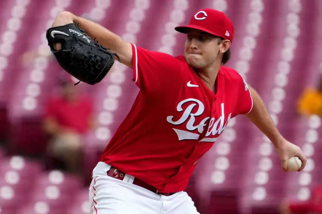 Cincinnati Reds vs Chicago Cubs Picks and Predictions May 25th 2025 2 A pitcher in a red Cincinnati Reds jersey winds up to throw a baseball on a field with spectators in the blurry background.