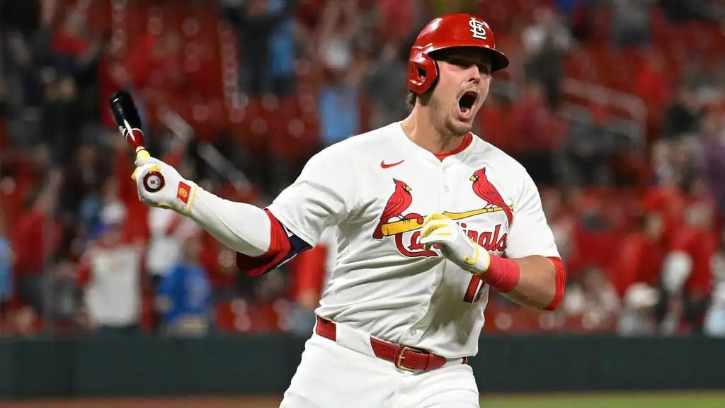 St. Louis Cardinals vs New York Mets Picks and Predictions May 4th 2025 2 A baseball player in a St. Louis Cardinals uniform celebrates, holding a bat, with a cheering crowd