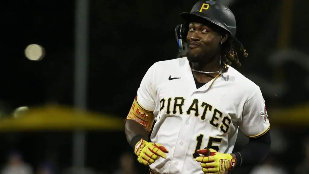 Pittsburgh Pirates vs Chicago Cubs Picks and Predictions May 1st 2025 1 A Pittsburgh Pirates baseball player in a white jersey with "PIRATES" across the chest, running on the field at night.