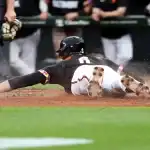 Baltimore Orioles player slides into home plate during matchup with Chicago White Sox on May 31, 2025