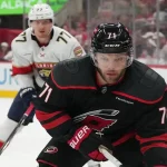 Carolina Hurricanes player handles the puck with Florida Panthers defender in pursuit during May 24, 2025 playoff game.