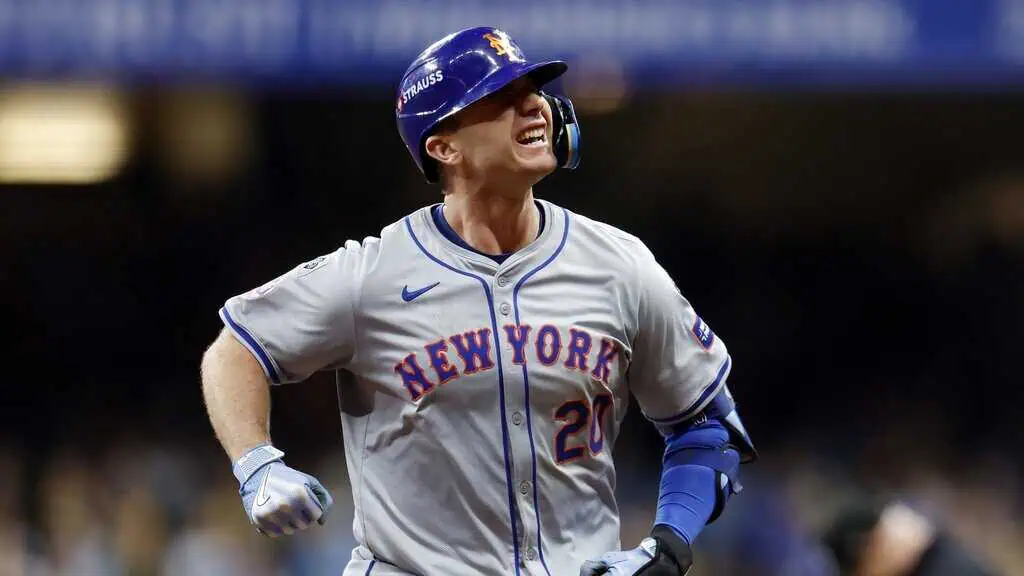 New York Mets vs Pittsburgh Pirates Picks and Predictions May 12th 2025 2 A baseball player in a gray New York Mets uniform celebrates after a hit, showcasing excitement and determination on the field.