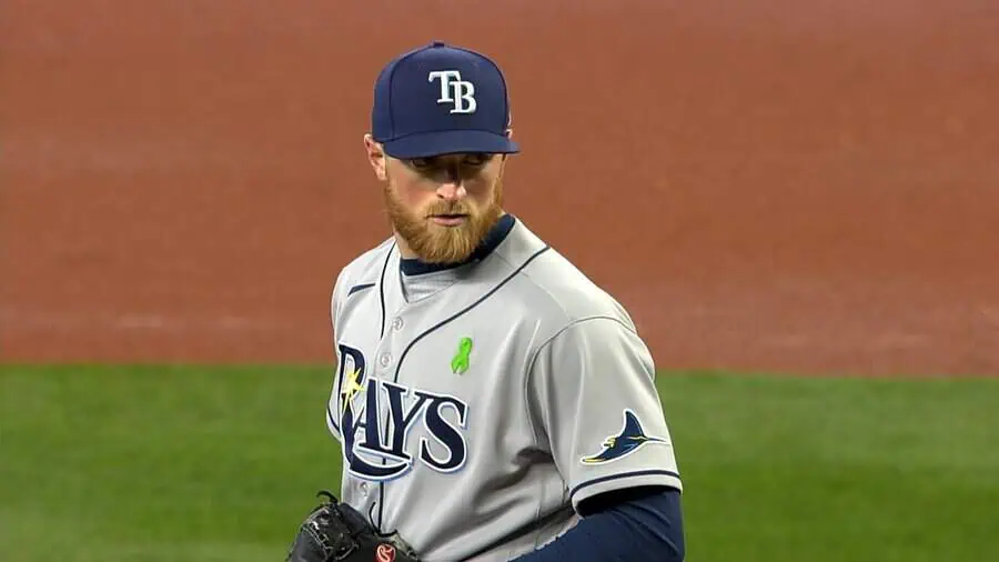 Tampa Bay Rays vs Milwaukee Brewers Picks and Predictions May 11th 2025 2 A baseball player in a gray Tampa Bay Rays uniform stands on the mound, poised to pitch, with a green ribbon pinned on his jersey.