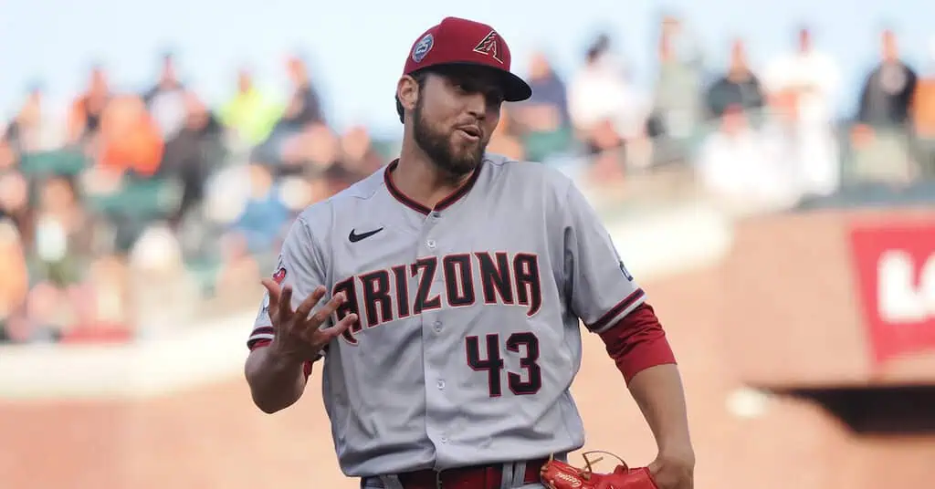 Detroit Tigers vs Cleveland Guardians Picks and Predictions May 23rd 2025 2 A baseball player wearing a red uniform with "ARIZONA 43" printed on it, standing on the field.
