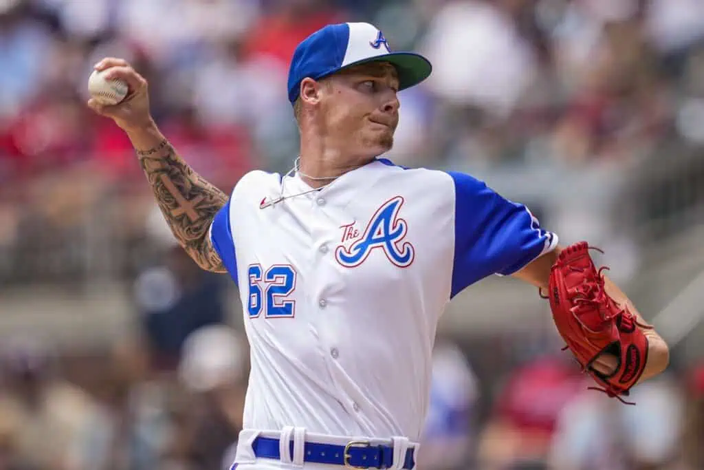 Atlanta Braves vs Cincinnati Reds Picks and Predictions May 5th 2025 2 A baseball player in a blue and white uniform winds up to pitch, showcasing a tattoo on his arm