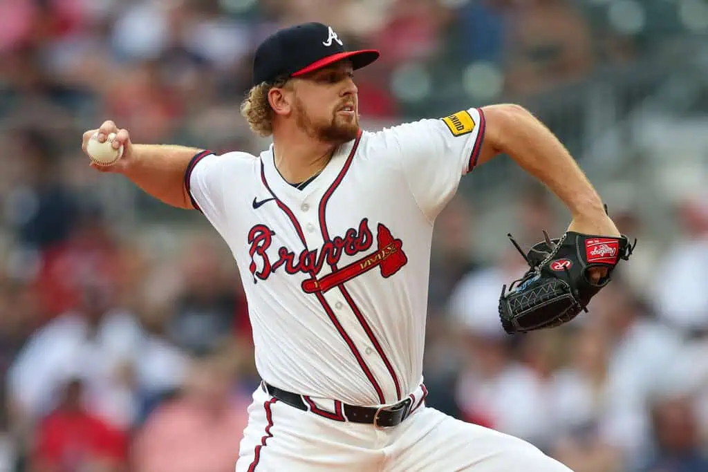 Atlanta Braves vs Cincinnati Reds Picks and Predictions May 8th 2025 2 A pitcher in a Braves uniform prepares to throw a baseball, showcasing his focused stance and athletic form on the field.
