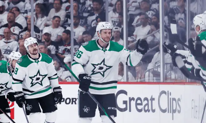 Winnipeg Jets vs Dallas Stars Picks and Predictions May 9th 2025 2 Dallas Stars players celebrate near the bench during NHL game