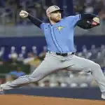 Rays pitcher winds up for pitch against Twins