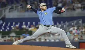 Rays pitcher winds up for pitch against Twins