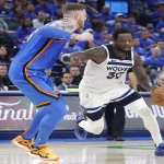 Minnesota Timberwolves player drives to the basket against Oklahoma City Thunder defender during May 24, 2025 playoff game.